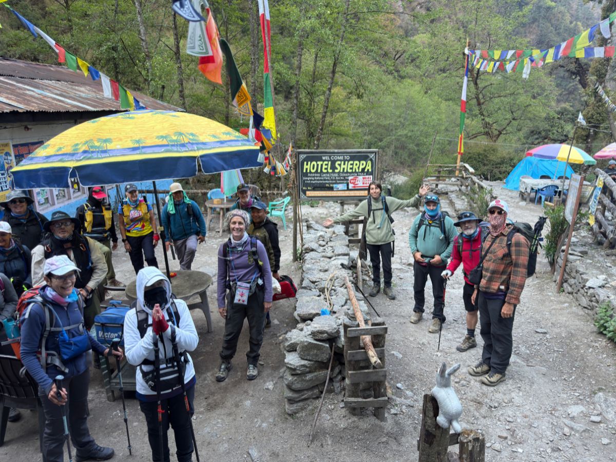 Hikers preparing for the trek with stretching at Lama Hotel