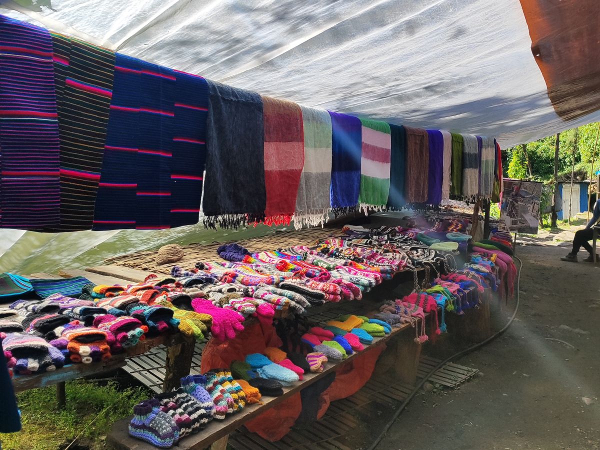 Supporting local vendors by purchasing souvenirs, hats, and gloves
